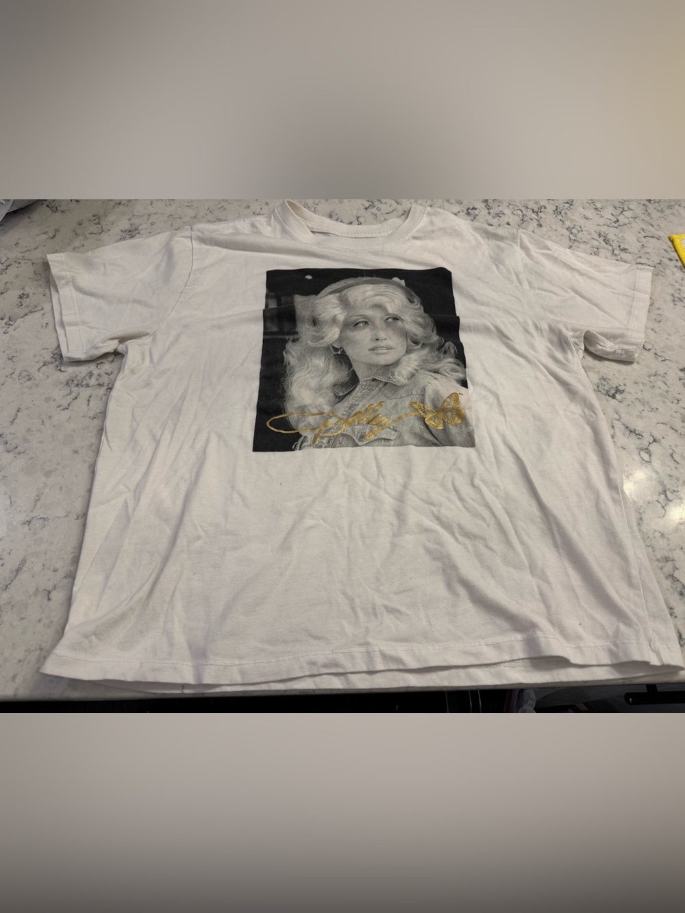 DOLLY PARTON 🦋 White M tee with black and white photo of Dolly. Gold butterfly